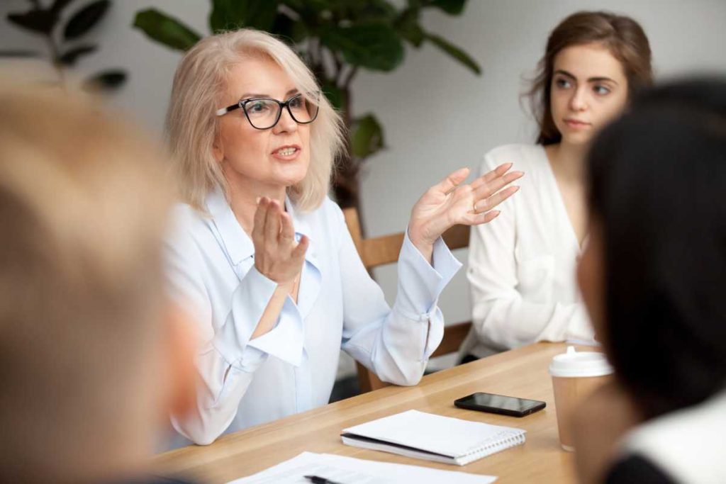 Image of female business owner of a privately held business running a meeting