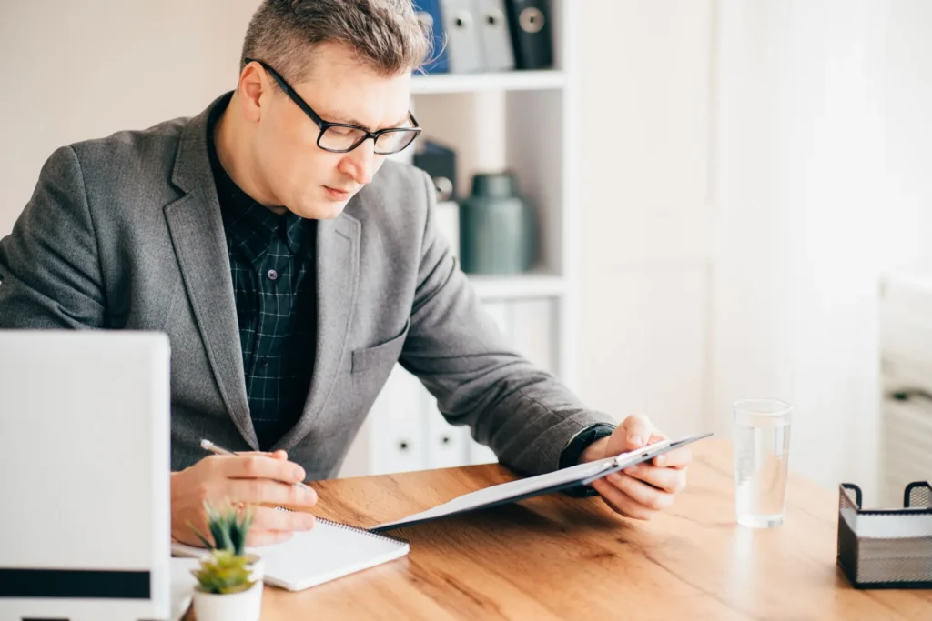 executive search Indiana – confident business owner reviewing strategy documents in office