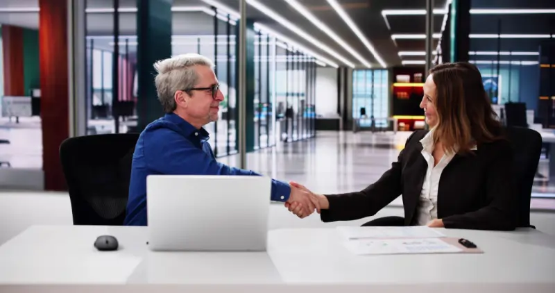 Executive handshake symbolizing RFT Search Group partnership with business owners