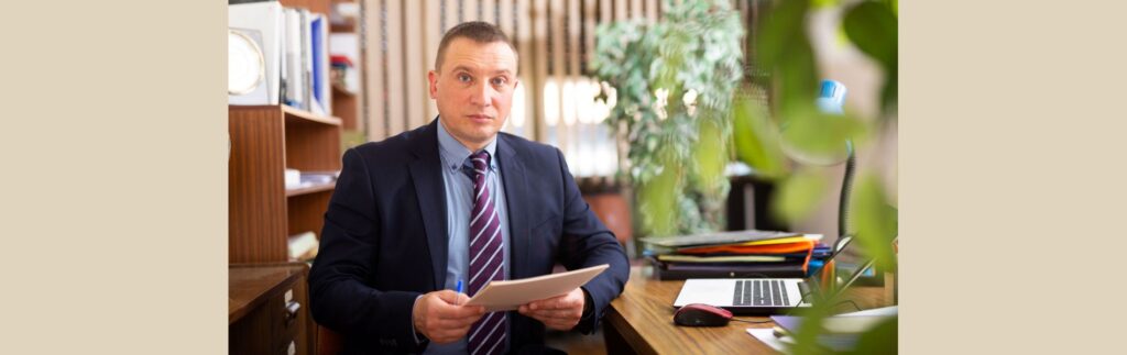 Business owner reviewing hiring decisions at desk representing executive search for companies