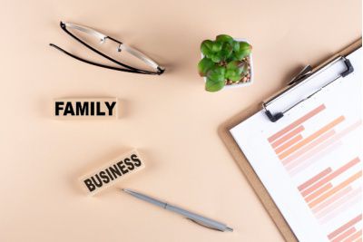 Wooden blocks spelling family business on a desk, representing retained executive search for family owned businesses