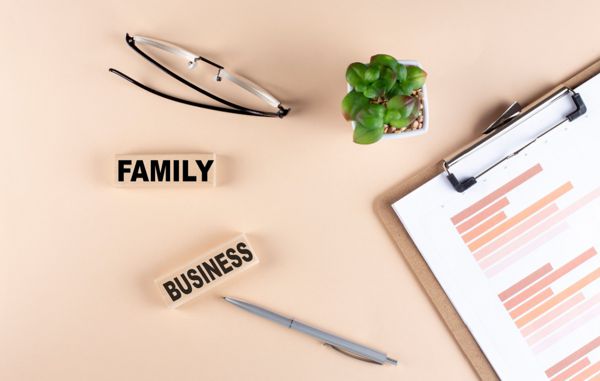 Family owned business executive search, wooden blocks spelling family business on a desk