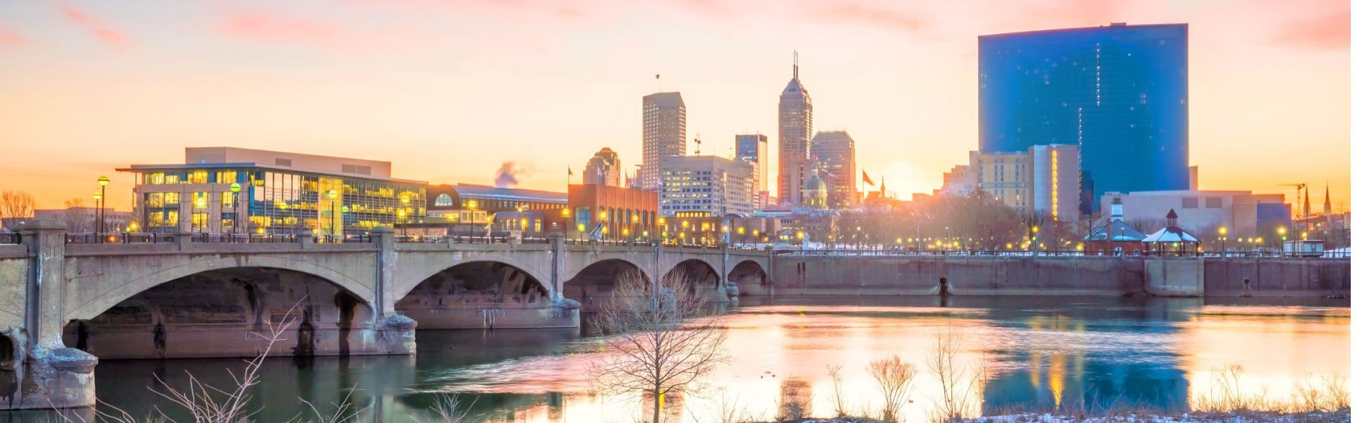 Indianapolis skyline at sunset with White River bridge representing executive search for Indianapolis business owners
